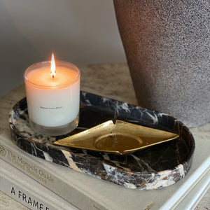 ellipse marble stone tray catchall with candle and vintage ash tray on design books